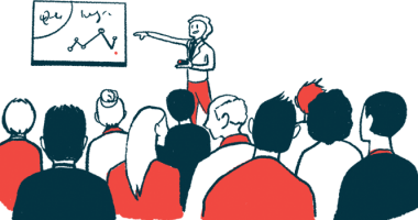 A conference speaker points to a chart with data during a presentation.