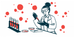 A scientist conducts tests in a lab using petri dishes and vials of blood.